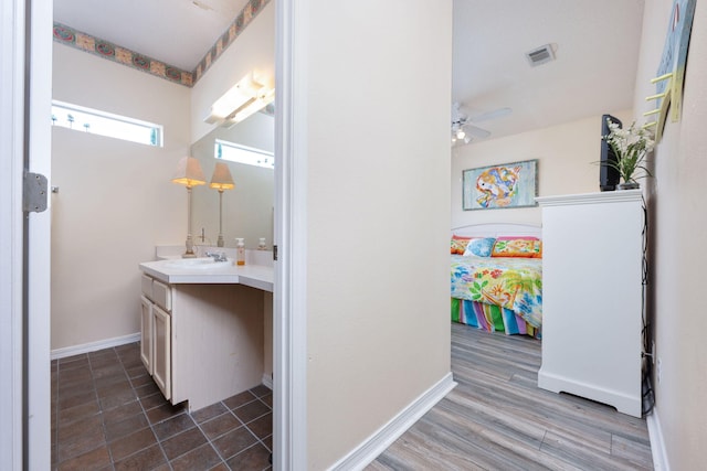 775 Gulf Shore Dr Unit 9222, Destin, FL 32541 - bathroom featuring vanity, ceiling fan, baseboards, and wood finished floors