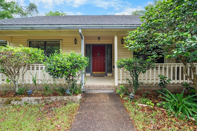 102 Bermuda Way, Niceville, FL 32578 - view of exterior entry featuring a porch and a shingled roof