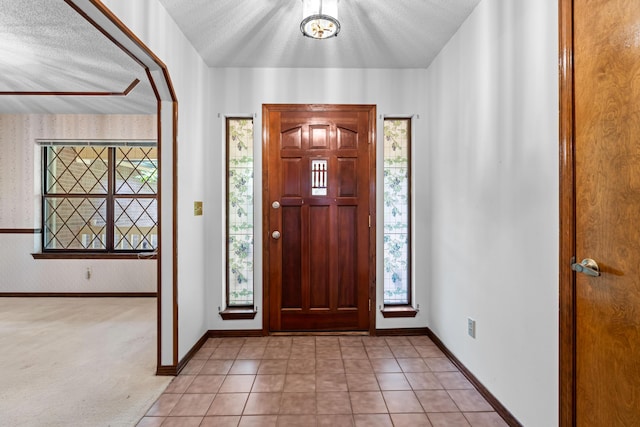102 Bermuda Way, Niceville, FL 32578 - foyer with baseboards, a textured ceiling, and light tile patterned flooring