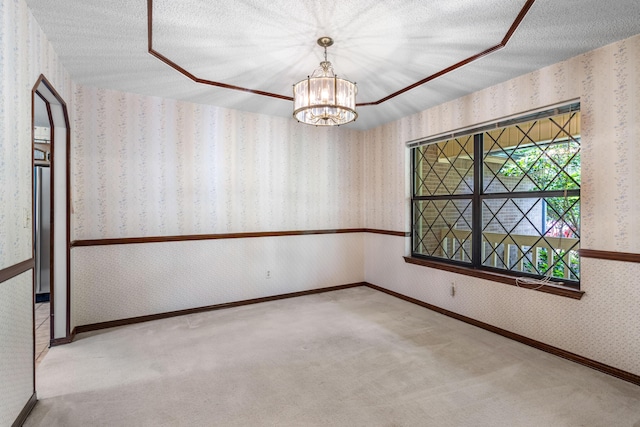 102 Bermuda Way, Niceville, FL 32578 - empty room with wallpapered walls, a chandelier, carpet floors, baseboards, and a textured ceiling