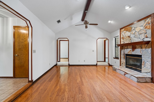 102 Bermuda Way, Niceville, FL 32578 - unfurnished living room with a ceiling fan, light wood-style flooring, a stone fireplace, and baseboards