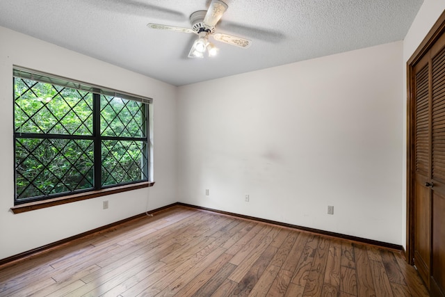 102 Bermuda Way, Niceville, FL 32578 - empty room featuring wood finished floors, ceiling fan, baseboards, and a textured ceiling