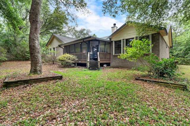 102 Bermuda Way, Niceville, FL 32578 - back of house with a chimney, a sunroom, and brick siding