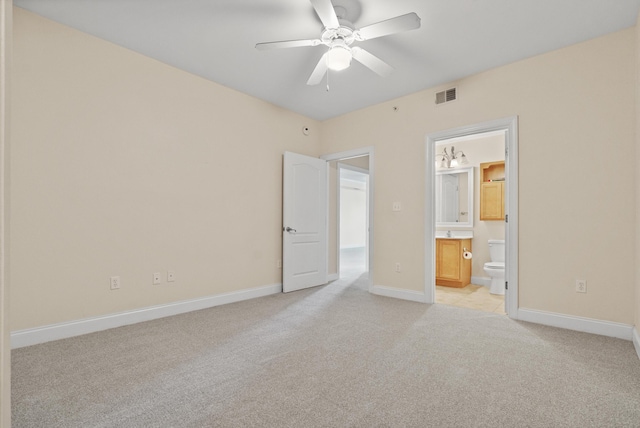 251 Mattie M Kelly Blvd Unit 203, Destin, FL 32541 - unfurnished bedroom with light colored carpet, connected bathroom, baseboards, and a ceiling fan