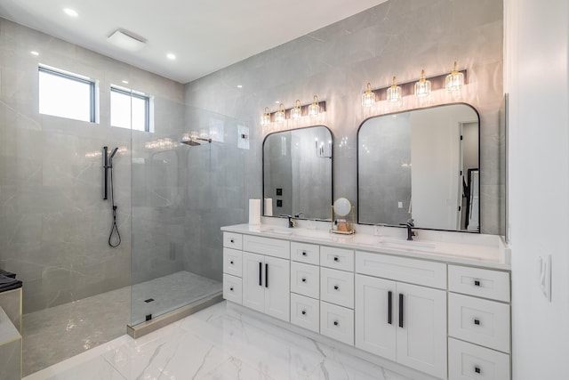 full bathroom with marble tiled floors, double vanity, and a walk in shower