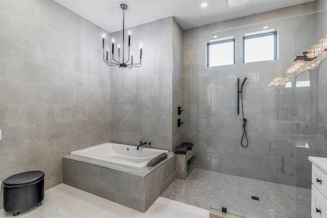 bathroom featuring a garden tub, a chandelier, a walk in shower, tile walls, and vanity