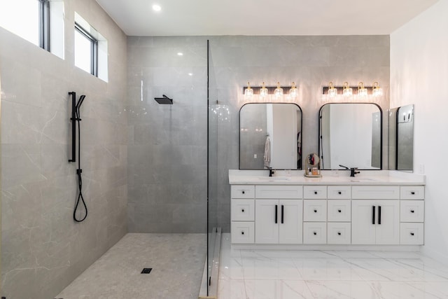 full bath with double vanity, marble finish flooring, and a walk in shower