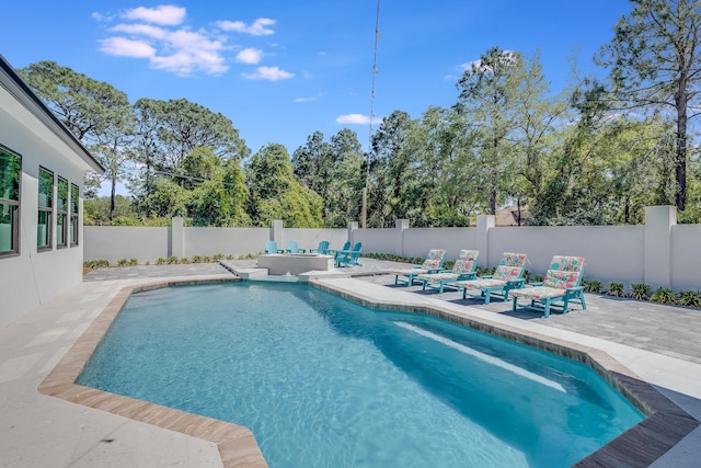 view of pool with a patio and a fenced backyard