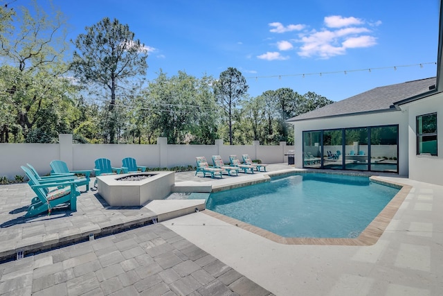 view of pool featuring an outdoor fire pit, a patio, and a fenced backyard