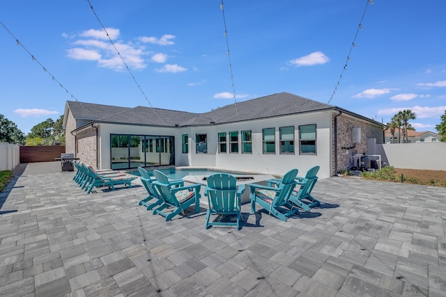 back of property featuring a patio area, a fenced backyard, and brick siding