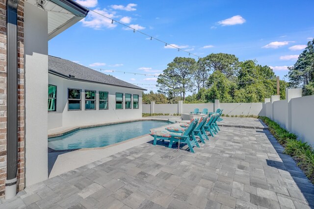 view of swimming pool with a patio area and a fenced backyard