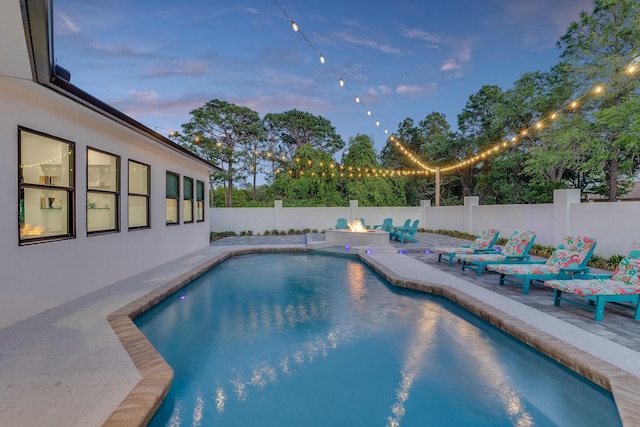 view of swimming pool with a patio and a fenced backyard