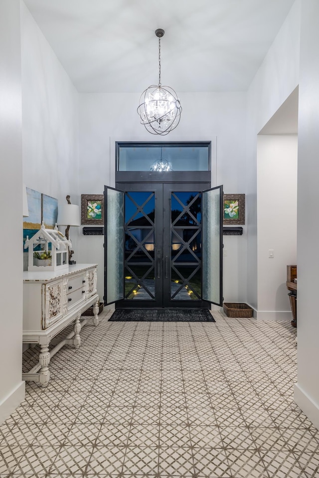 entrance foyer featuring a chandelier and baseboards