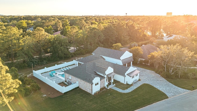 aerial view of property and surrounding area with a heavily wooded area