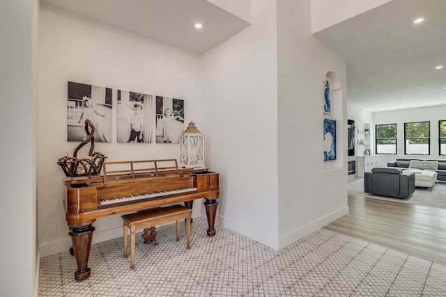 hall with recessed lighting and baseboards