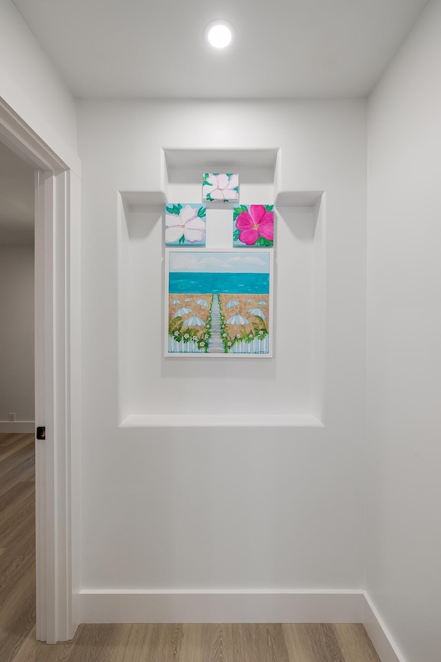 detailed view of wood finished floors, baseboards, and recessed lighting