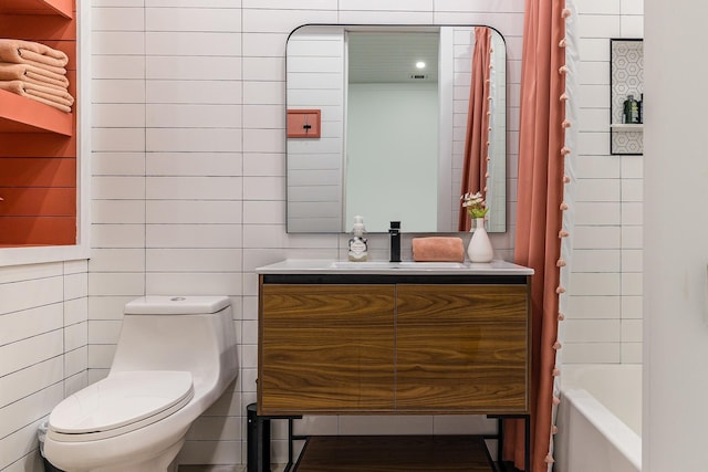 bathroom with tile walls, toilet, vanity, and shower / bathtub combination with curtain