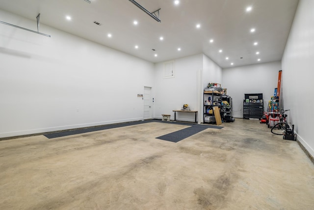 garage featuring recessed lighting and baseboards
