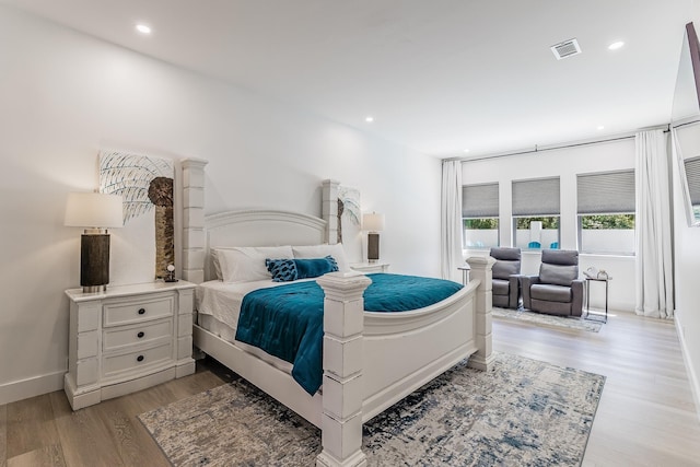bedroom with light wood-type flooring, baseboards, and recessed lighting