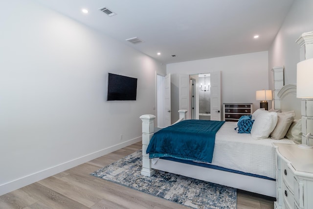 bedroom featuring light wood-type flooring, a chandelier, recessed lighting, and baseboards