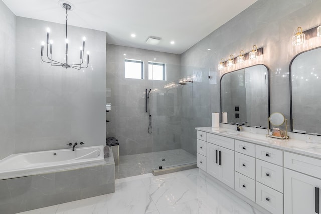 full bath featuring a chandelier, a bath, double vanity, and a tile shower