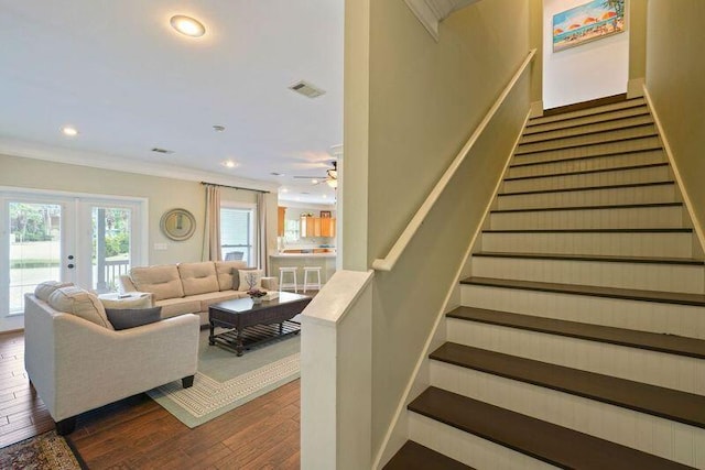 stairway featuring french doors, wood finished floors, crown molding, recessed lighting, and a ceiling fan