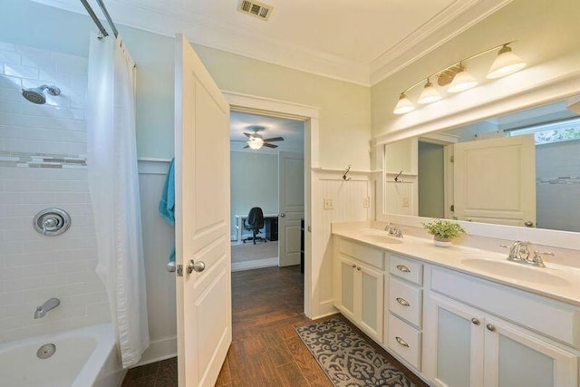 bathroom with crown molding, double vanity, shower / bath combo with shower curtain, wood finished floors, and ceiling fan