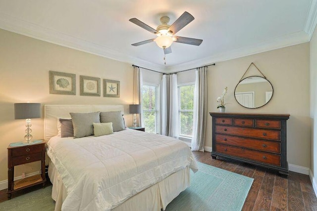 bedroom with ornamental molding, baseboards, dark wood finished floors, and a ceiling fan