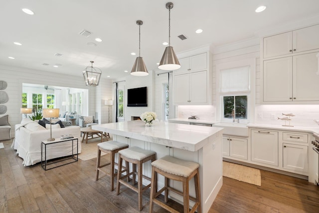 17 Compass Point Way, Watersound, FL 32461 - kitchen with open floor plan, recessed lighting, wood finished floors, white cabinets, and a kitchen island