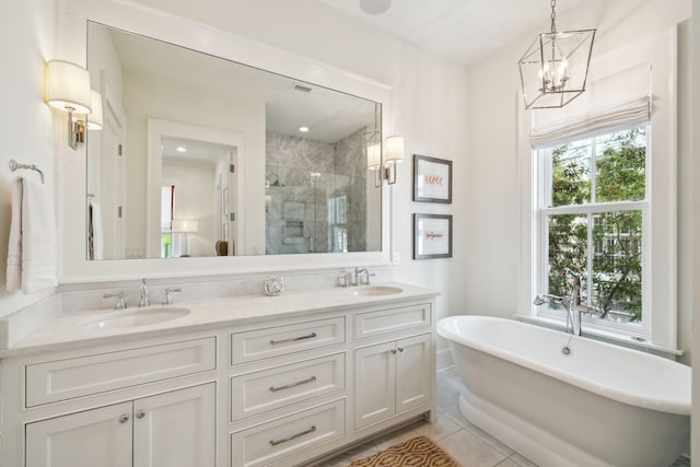17 Compass Point Way, Watersound, FL 32461 - full bathroom with a stall shower, double vanity, tile patterned flooring, a soaking tub, and a chandelier