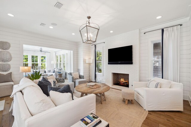 17 Compass Point Way, Watersound, FL 32461 - living room with a fireplace, recessed lighting, wood finished floors, ceiling fan, and a chandelier