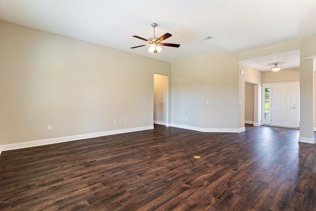 unfurnished room with dark wood-type flooring, a ceiling fan, and baseboards