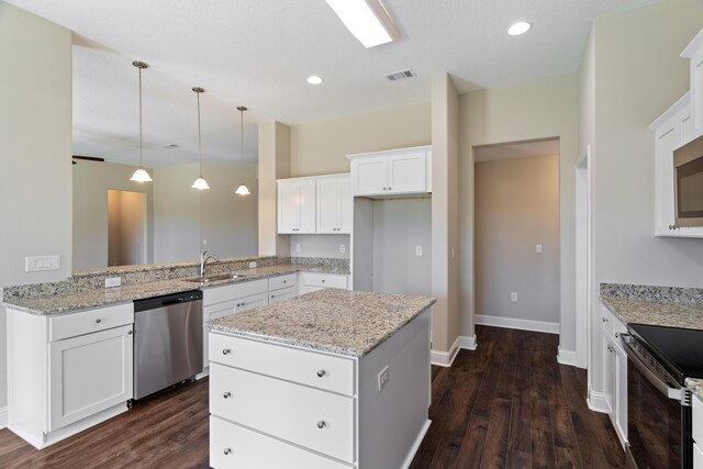kitchen featuring dishwasher, a sink, dark wood-type flooring, white cabinets, and recessed lighting