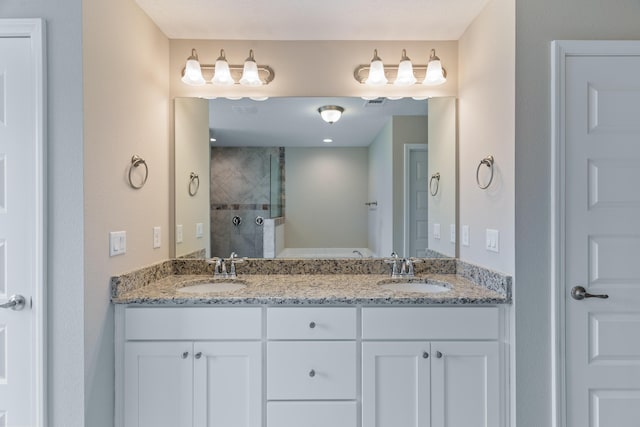 bathroom featuring a stall shower and double vanity