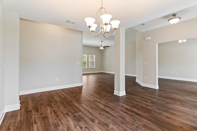 unfurnished room with a chandelier, dark wood finished floors, and baseboards