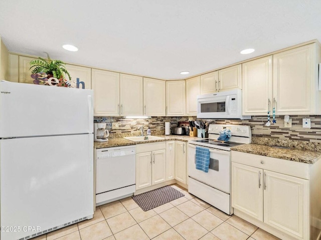 23223 Front Beach Rd Unit A114, Panama City Beach, FL 32413 - kitchen with white appliances, a sink, cream cabinetry, light tile patterned flooring, and decorative backsplash