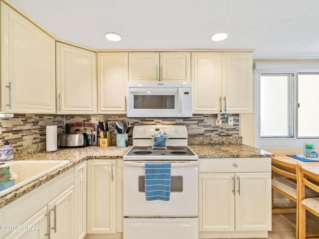 23223 Front Beach Rd Unit A114, Panama City Beach, FL 32413 - kitchen with white appliances, cream cabinets, backsplash, a sink, and recessed lighting