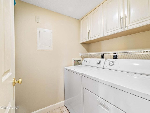 23223 Front Beach Rd Unit A114, Panama City Beach, FL 32413 - laundry room with washing machine and dryer, electric panel, cabinet space, baseboards, and light tile patterned flooring