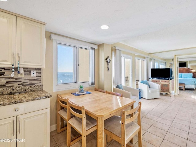 23223 Front Beach Rd Unit A114, Panama City Beach, FL 32413 - dining area featuring light tile patterned floors, a textured ceiling, and baseboards