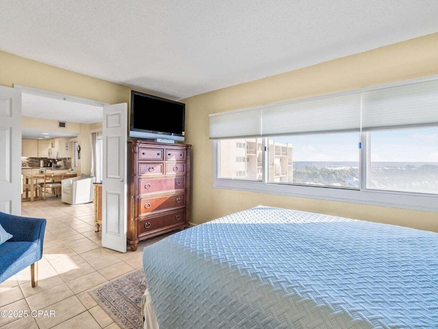 23223 Front Beach Rd Unit A114, Panama City Beach, FL 32413 - bedroom featuring light tile patterned floors and a textured ceiling