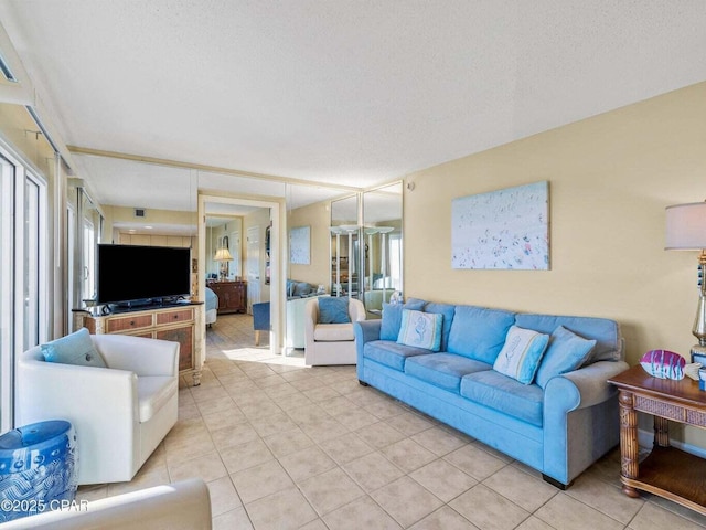 23223 Front Beach Rd Unit A114, Panama City Beach, FL 32413 - living room with light tile patterned floors, healthy amount of natural light, and a textured ceiling