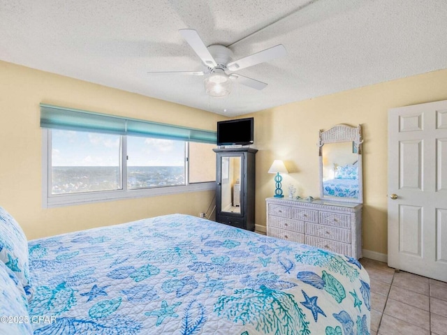 23223 Front Beach Rd Unit A114, Panama City Beach, FL 32413 - tiled bedroom featuring a ceiling fan and a textured ceiling
