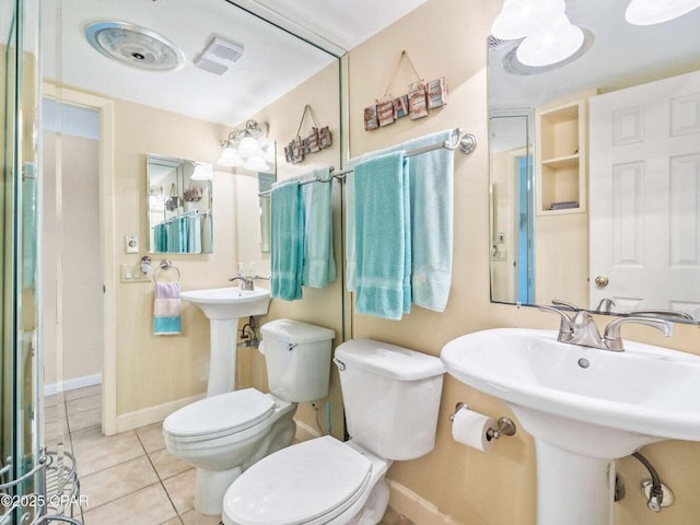 23223 Front Beach Rd Unit A114, Panama City Beach, FL 32413 - bathroom with toilet, tile patterned flooring, baseboards, and a sink