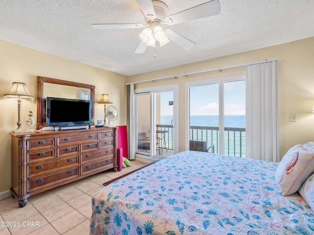 23223 Front Beach Rd Unit A114, Panama City Beach, FL 32413 - bedroom with access to exterior, a textured ceiling, light tile patterned flooring, and a ceiling fan