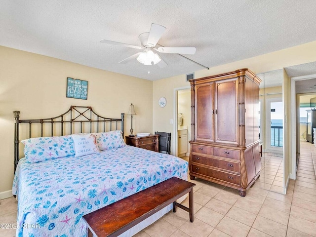 23223 Front Beach Rd Unit A114, Panama City Beach, FL 32413 - bedroom featuring a textured ceiling, light tile patterned floors, and a ceiling fan