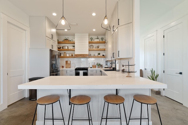 kitchen featuring open shelves, stainless steel range, concrete floors, a peninsula, and recessed lighting