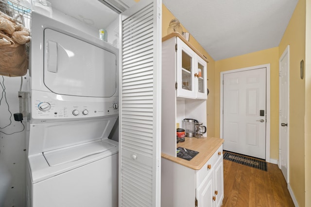 439 Big Cedar Rd, Ponce De Leon, FL 32455 - laundry area featuring stacked washer / dryer, dark wood-type flooring, and baseboards