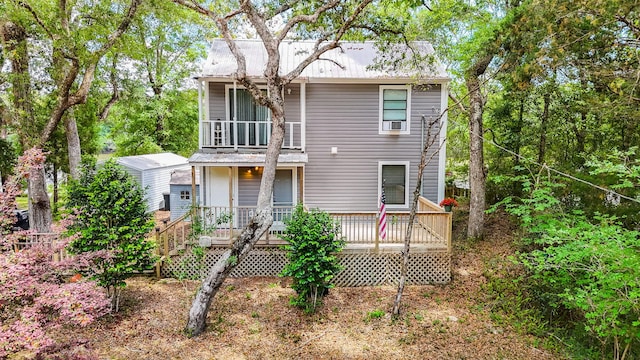 439 Big Cedar Rd, Ponce De Leon, FL 32455 - back of property featuring a balcony, metal roof, and a wooden deck