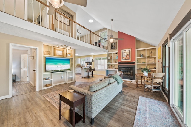 439 Big Cedar Rd, Ponce De Leon, FL 32455 - living area featuring ceiling fan, high vaulted ceiling, wood finished floors, a fireplace, and baseboards