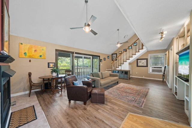 439 Big Cedar Rd, Ponce De Leon, FL 32455 - living room featuring stairway, a ceiling fan, baseboards, wood finished floors, and high vaulted ceiling